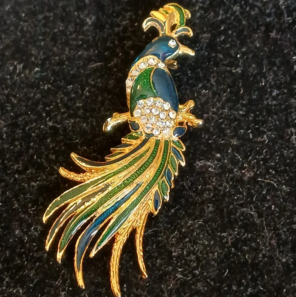 Goldtone peacock brooch with blue and green accents